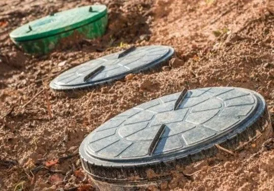 Septic system lids installed on a newly prepared site.